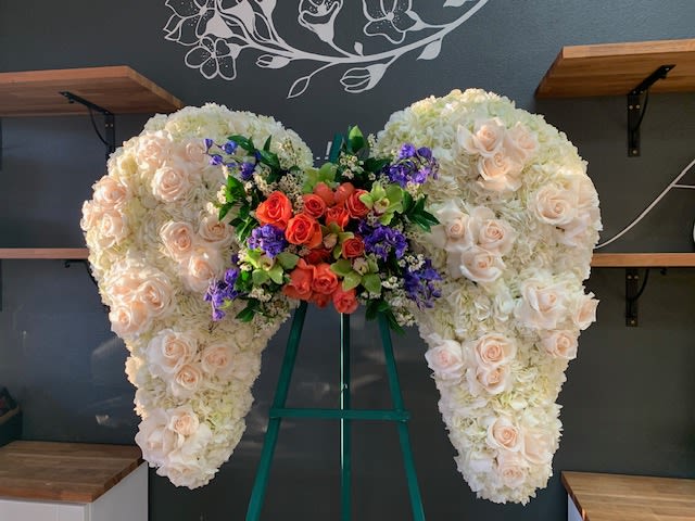 Large heart-shaped floral arrangement with cream and peach roses