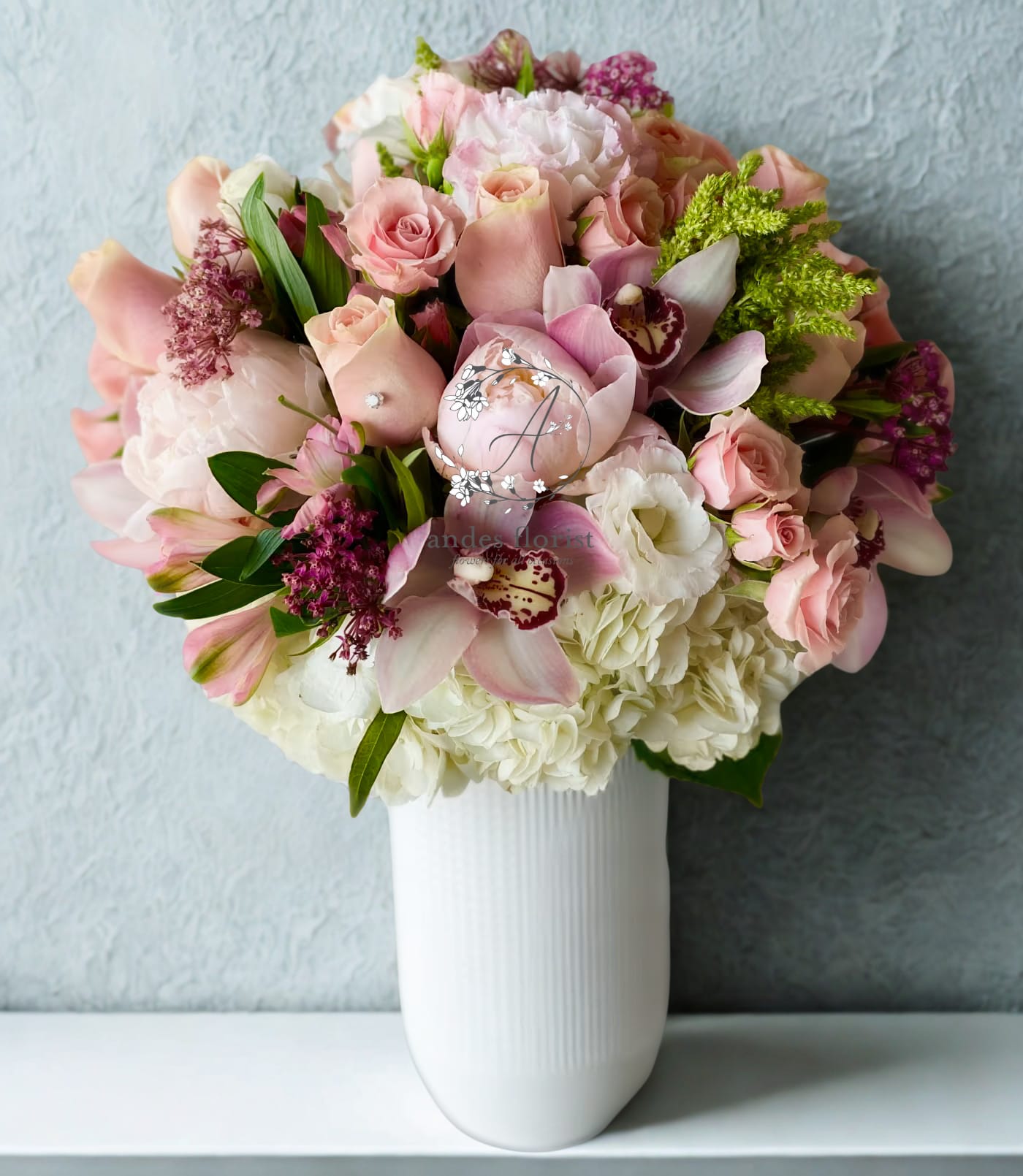 Pink and white mixed bouquet in a white vase