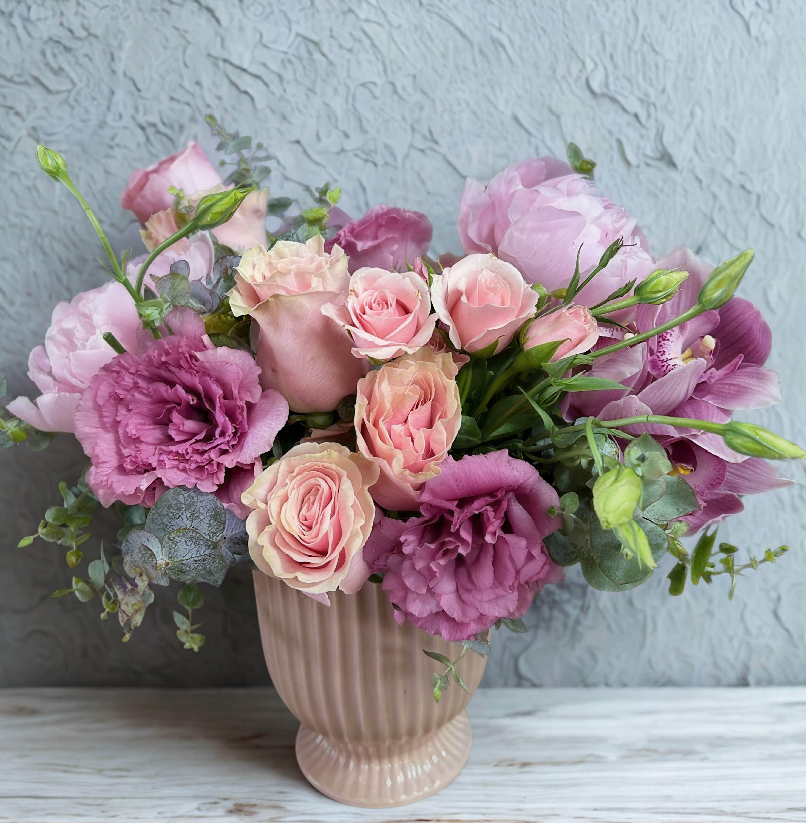 Pink and lavender bouquet in a ribbed blush vase