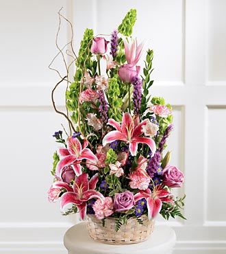 Tall basket arrangement with pink lilies, roses, and purple flowers