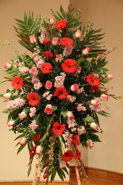 Tall floral spray with red gerbera daisies and pink roses