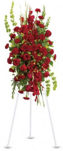 Tall standing spray of red roses and carnations on a white easel