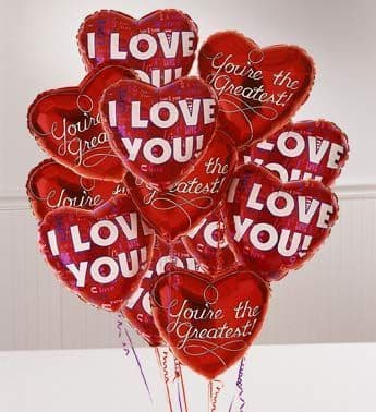 Cluster of red heart-shaped balloons with love messages
