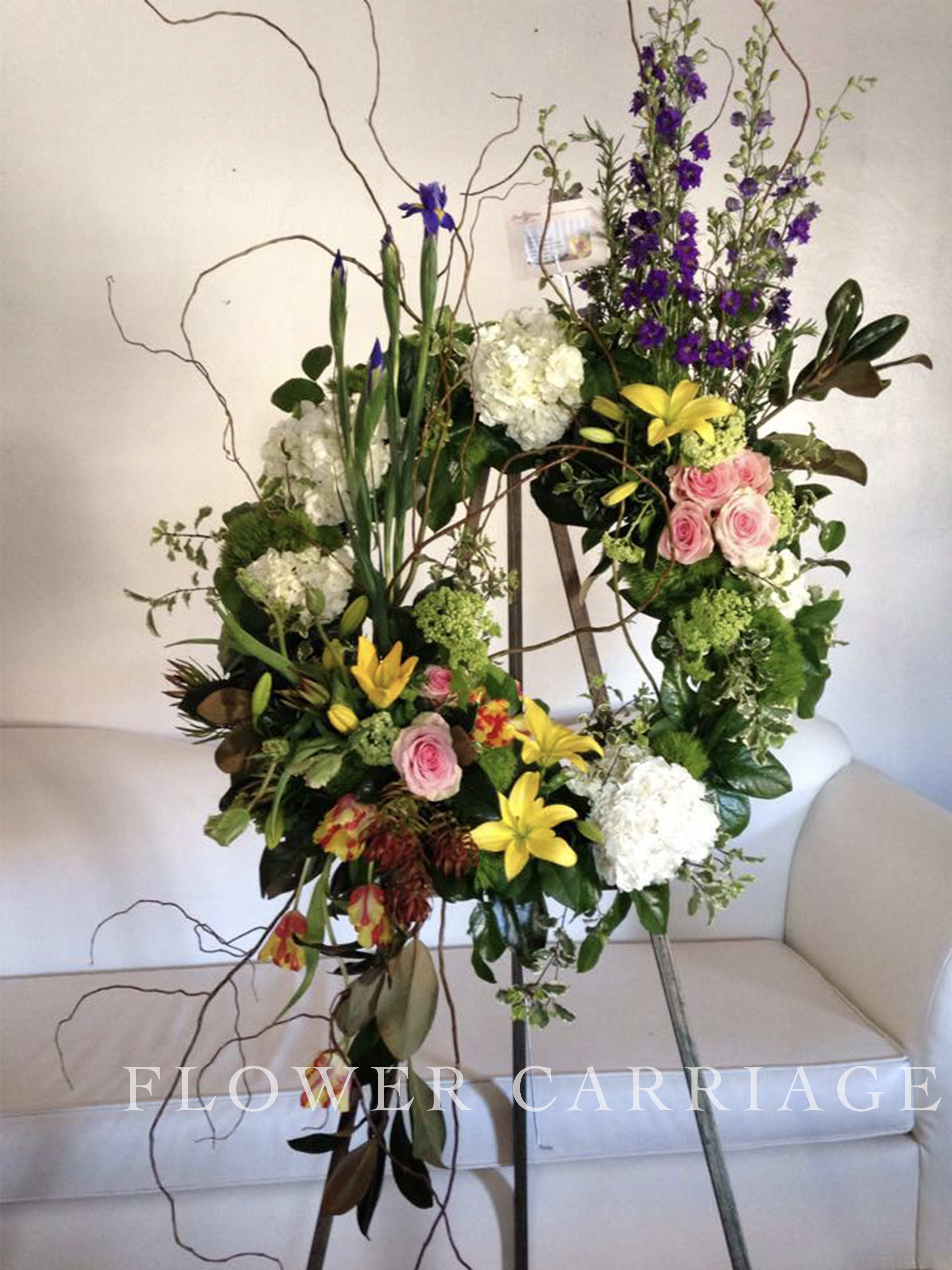 Tall floral standing arrangement with pink roses, yellow lilies, and white hydrangeas