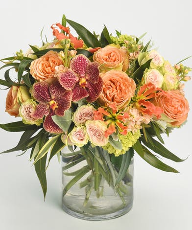 Unique Orchids - Experience fall in the tropics with these unique blooms.  This arrangement features: garden roses, spray garden roses, green apple hydrangea, wild tulips, tropical leafs. 