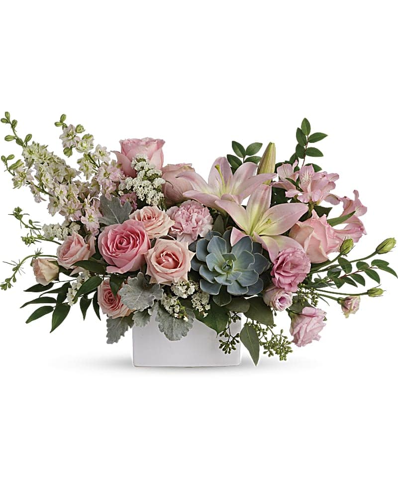 Pink roses and lilies arranged in a white rectangular vase
