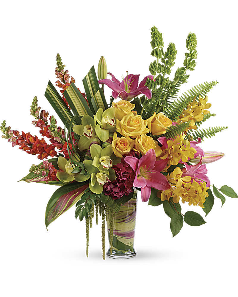 Tropical bouquet with pink lilies, yellow roses, and orchids in a glass vase