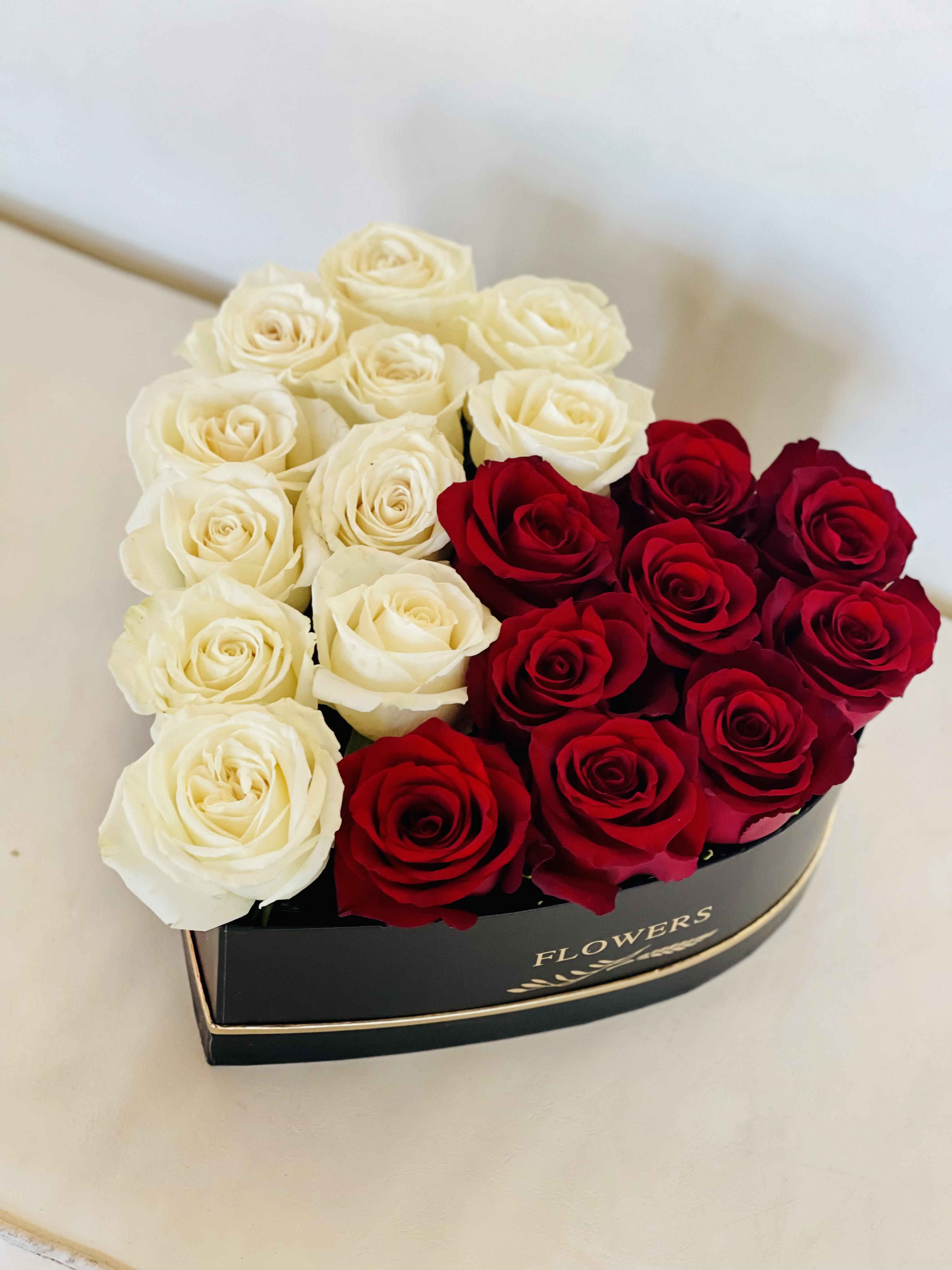 Heart-shaped box of red and white roses