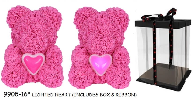 Pink rose teddy bears with heart accents beside a clear gift box