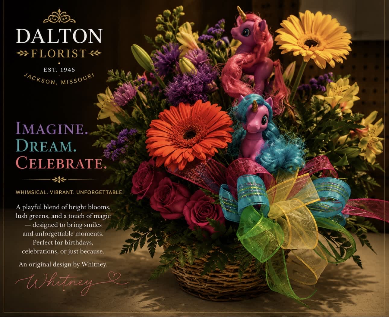 Bright mixed flower basket with two toy unicorns and a rainbow ribbon bow