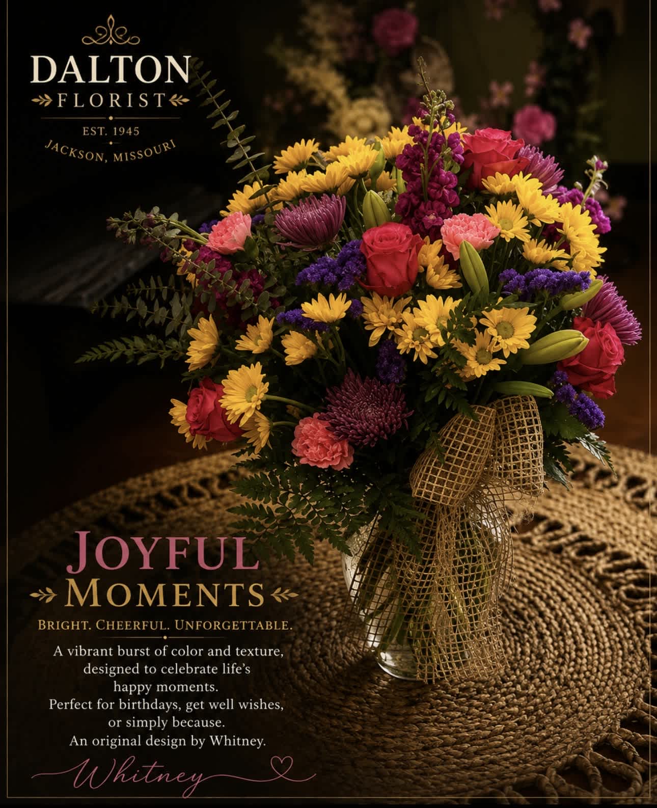 Colorful mixed bouquet in a glass vase with a gold ribbon