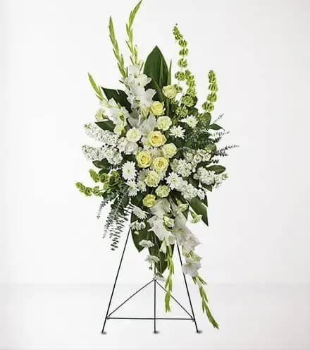 Tall white and pale green floral standing spray on an easel
