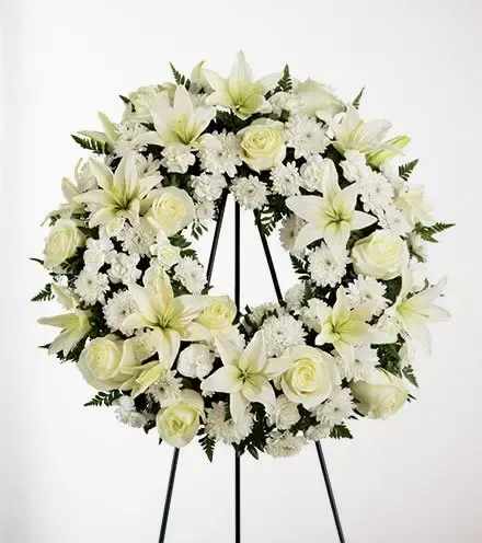 White floral wreath on a black easel