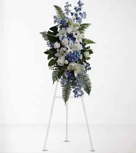 White and blue floral standing spray on a metal easel