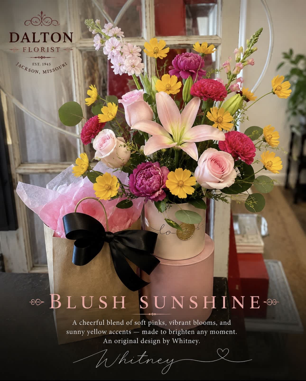 Mixed bouquet with pink roses, lilies, and yellow daisies in a gift box