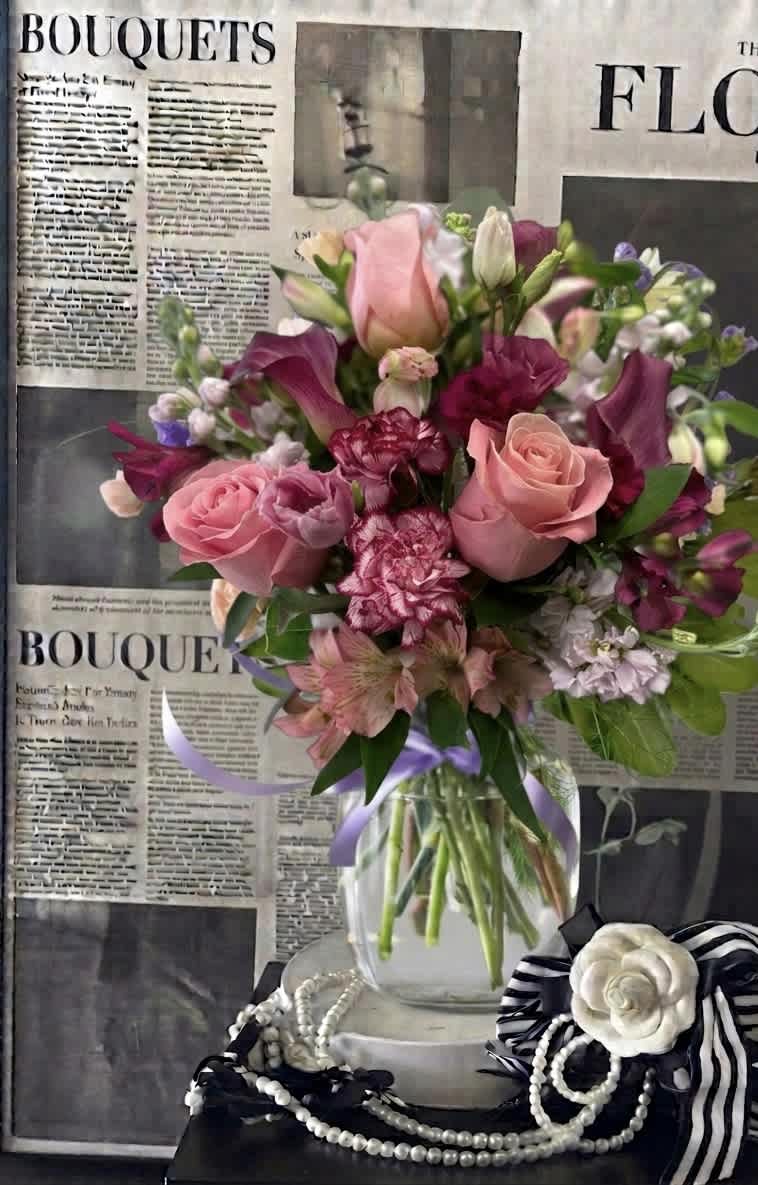 Pink and purple mixed bouquet in a clear glass vase