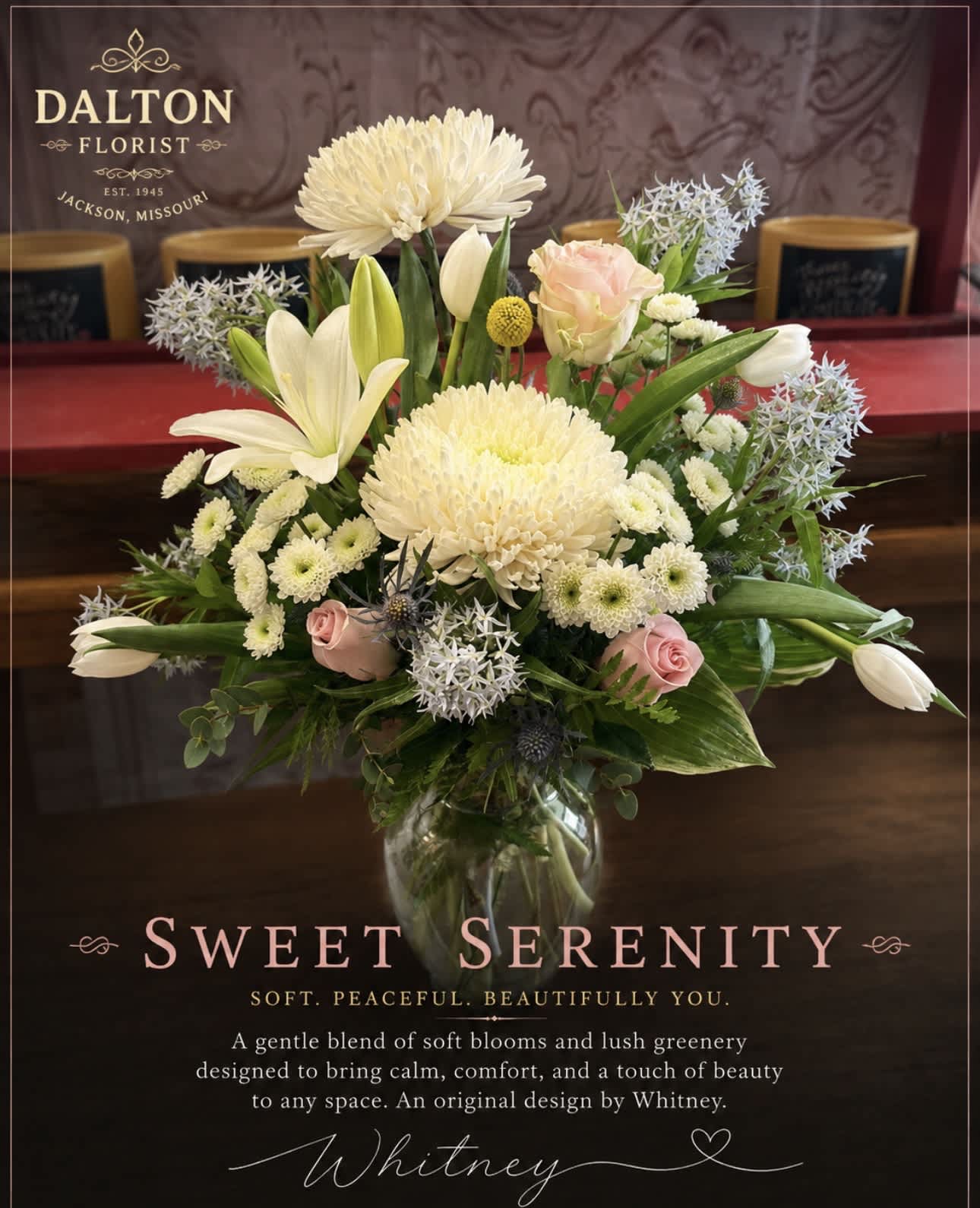Cream and pink floral arrangement in a clear glass vase