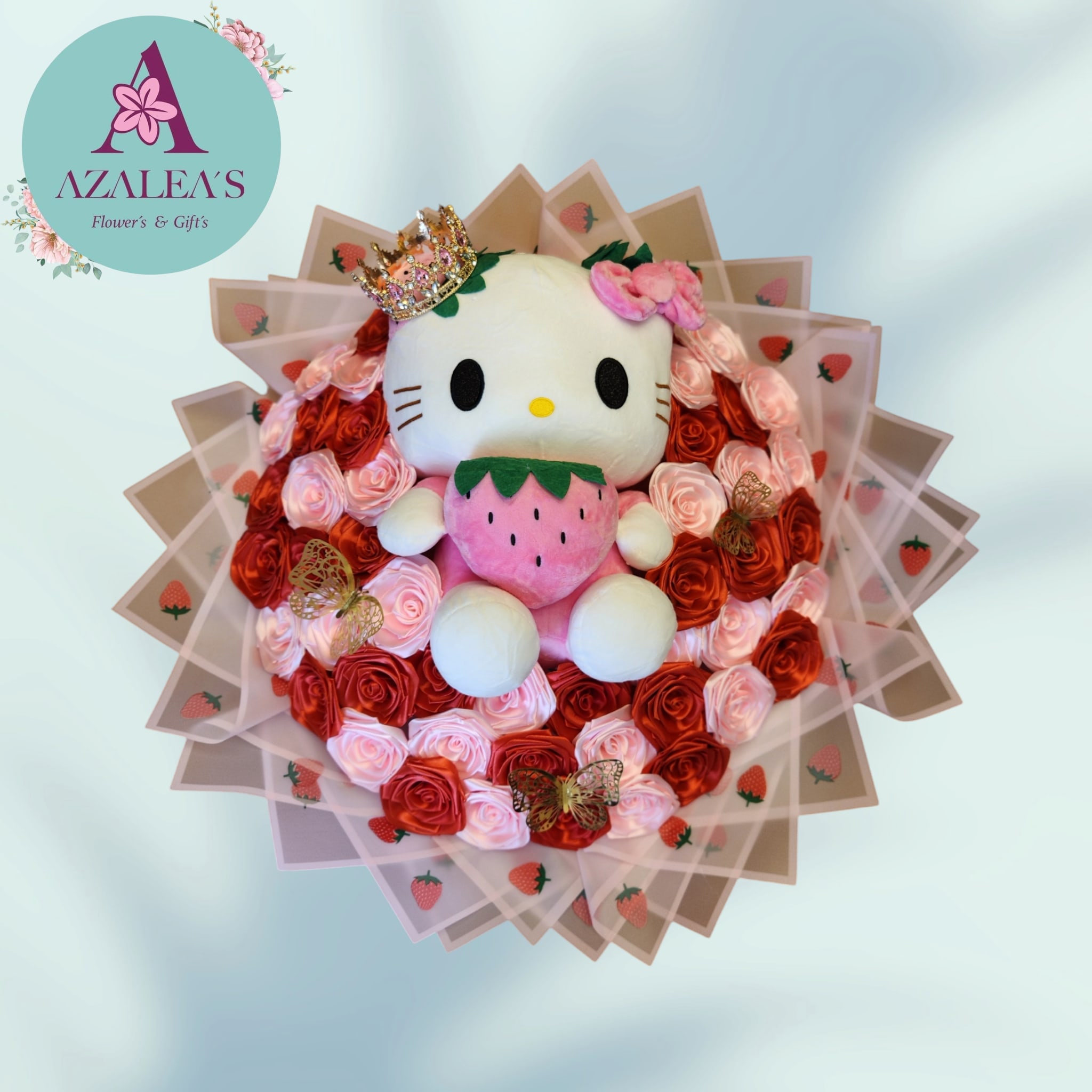 Hello Kitty plush surrounded by red and pink roses with strawberry wrapping