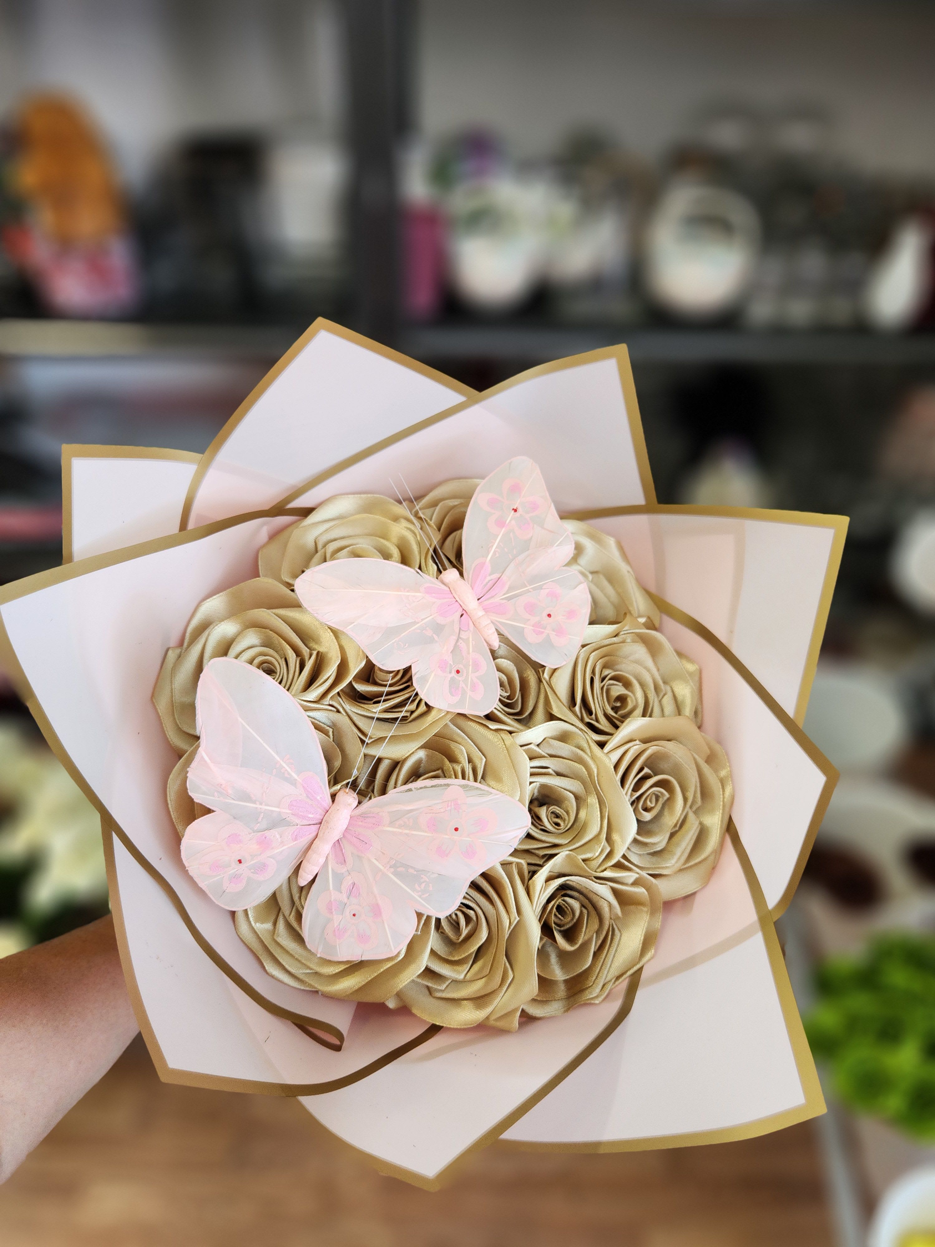 Bouquet of gold satin roses with pink butterfly decorations