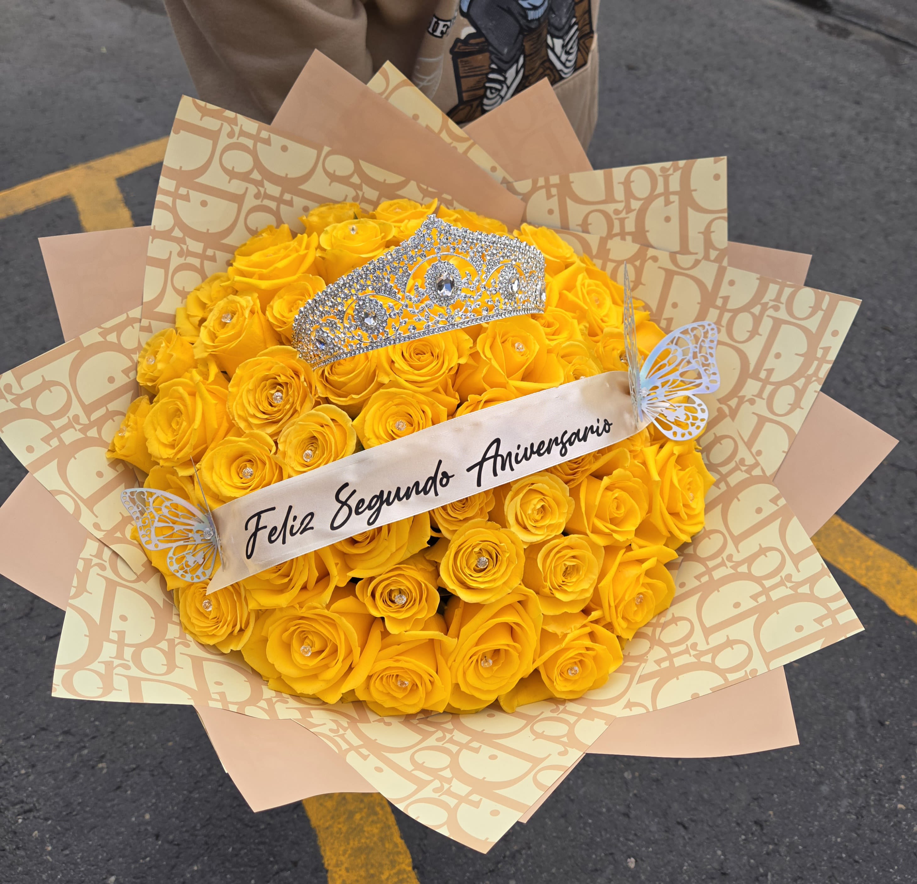 Yellow rose bouquet with a jeweled tiara and anniversary ribbon