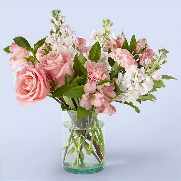 Pink and white mixed bouquet in a clear glass vase