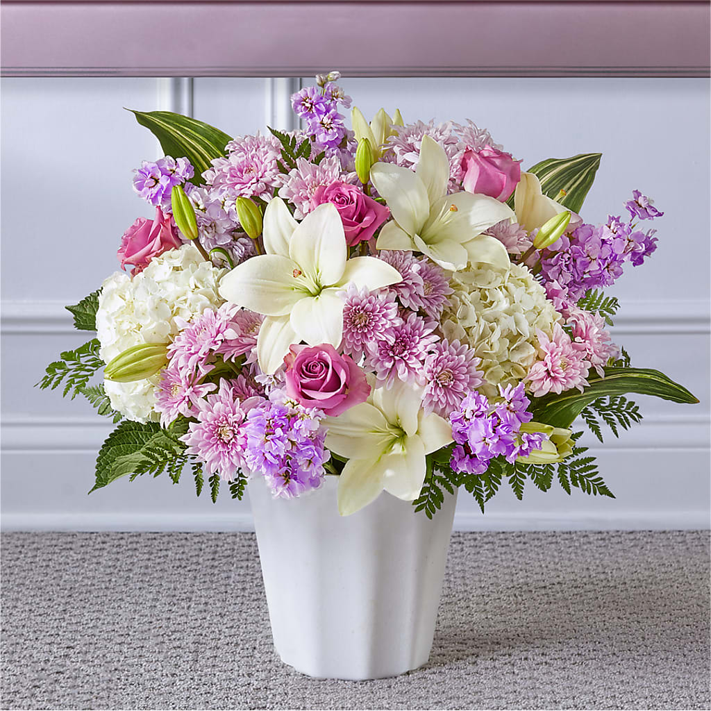 Pink and white floral arrangement in a white vase