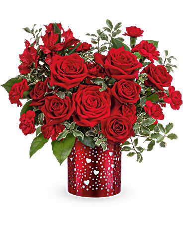 Red roses and carnations in a red heart-patterned vase