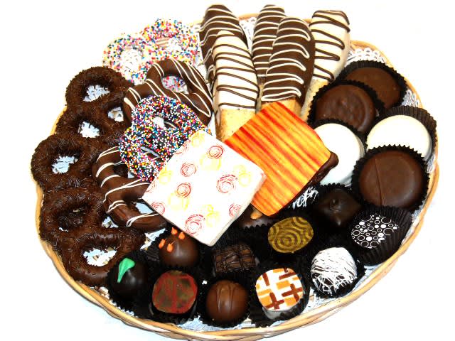 Basket of assorted chocolate-covered treats and decorated cookies