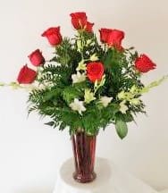 Deluxe Long Stem Red Roses arranged in a vase - How do you improve on perfection?  We have taken everyone's classic dozen roses and highlighted them with white dendrobium orchids.  Tres magnifique!  [Want us to use another color rose: white, pink, yellow, lavender, peach or orange.   Just let us know your rose color preference.  Unless we hear from you otherwise, we will use red roses.]