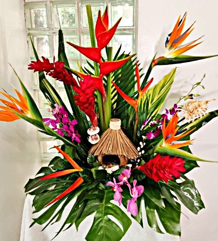 Hawaiian Life - Hawaiian life comes to you with this tropical arrangement full of birds of paradise, ginger, psittacorum, orchids, and protea, arranged around a tiki hut.   Say "Aloha" to your Miami recipient!