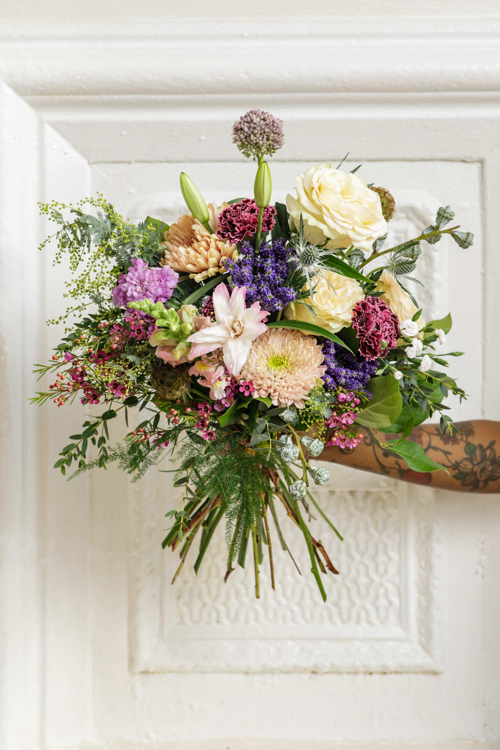 The Lush &amp; Large Bouquet - Designer's Choice  - Gift them this lush hand-tied bouquet, created using a fresh mix of unique and textural blooms designed by one of our floral artists.  **Please note that Brooklyn Blooms moves with the seasons. What you see pictured represents our style and the general size of the Lush N' Large bouquet.  Although it not be the same as the photo it will have the same beauty, uniqueness, and vibe. Please let us know in the florist notes if you have any color preferences, special requests, or love what's in the photo, otherwise, the Bloomies will make a tasteful decision for you! **  ***ALL SPECIAL REQUESTS MUST BE SPECIFIED IN THE FLORIST NOTES SO THAT OUR DESIGNERS ARE AWARE AND CAN DELIVER THE BEST SERVICE. COMMUNICATION IS KEY!!****  Upgrade Notes: Please note that with each upgrade the Bloomies will choose a mix of blooms, premium foliages, and filler to enhance your arrangement for the best presentation!  