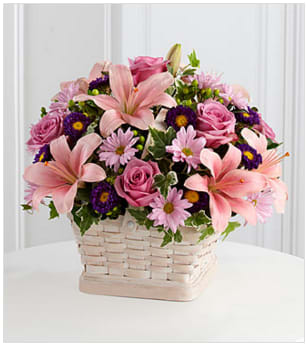 The FTD® Loving Sympathy™ Basket - The FTD® Loving Sympathy™ Basket is a wonderful way to convey your condolences for their loss. Lavender roses, pink Asiatic lilies, lavender daisies, purple matsumoto asters, green hypericum berries and lush greens are sweetly arranged in a square whitewash basket to create a lovely way to offer your caring kindness during this trying time. GOOD basket includes 14 stems. Approximately 14"H x 16"W. BETTER basket includes 19 stems. Approximately 15"H x 17"W. BEST basket includes 24 stems. Approximately 16"H x 20"W. Your purchase includes a complimentary personalized gift message.