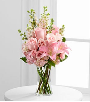 The FTD® Wishes &amp; Blessings™ Bouquet - The FTD® Wishes &amp; Blessings™ Bouquet is a stunning way to offer your condolences for their loss and commemorate the life of the deceased. Soft pink roses, spray roses, Oriental lilies, hydrangea and larkspur are brought together in a clear glass vase to create an eye-catching display of soft serenity. GOOD bouquet includes 13 stems. Approximately 20"H x 11"W. BETTER bouquet includes 16 stems. Approximately 23"H x 14"W. BEST bouquet includes 21 stems. Approximately 25"H x 16"W. Your purchase includes a complimentary personalized gift message.