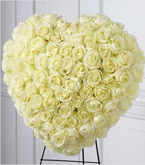 The FTD® Elegant Remembrance™ Standing Heart - The FTD® Elegant Remembrance™ Standing Heart is an exquisite display of peace and love. 77 Stems of white roses are artfully arranged in the shape of a heart and presented on a wire easel, creating a simply beautiful tribute for their final farewell service. Approximately 24"H x 22"W. Your purchase includes a complimentary personalized gift message.