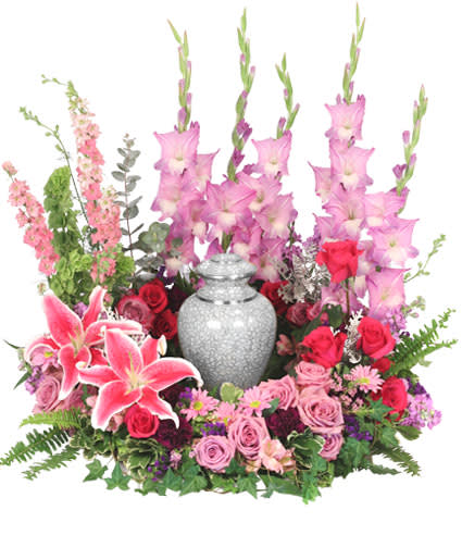 Pink and red floral arrangement with a silver urn centerpiece