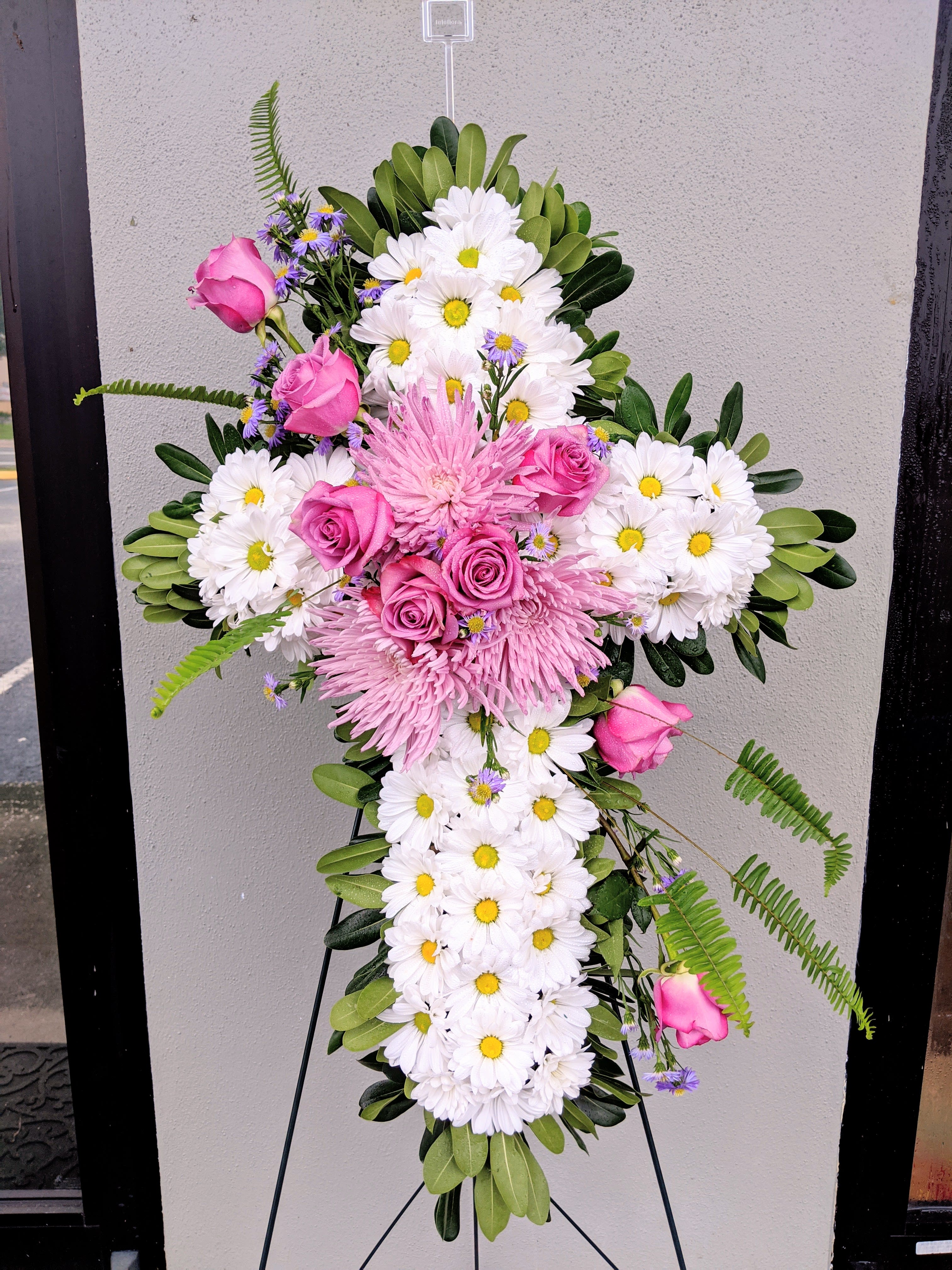 Cross-shaped floral spray with pink roses and white daisies