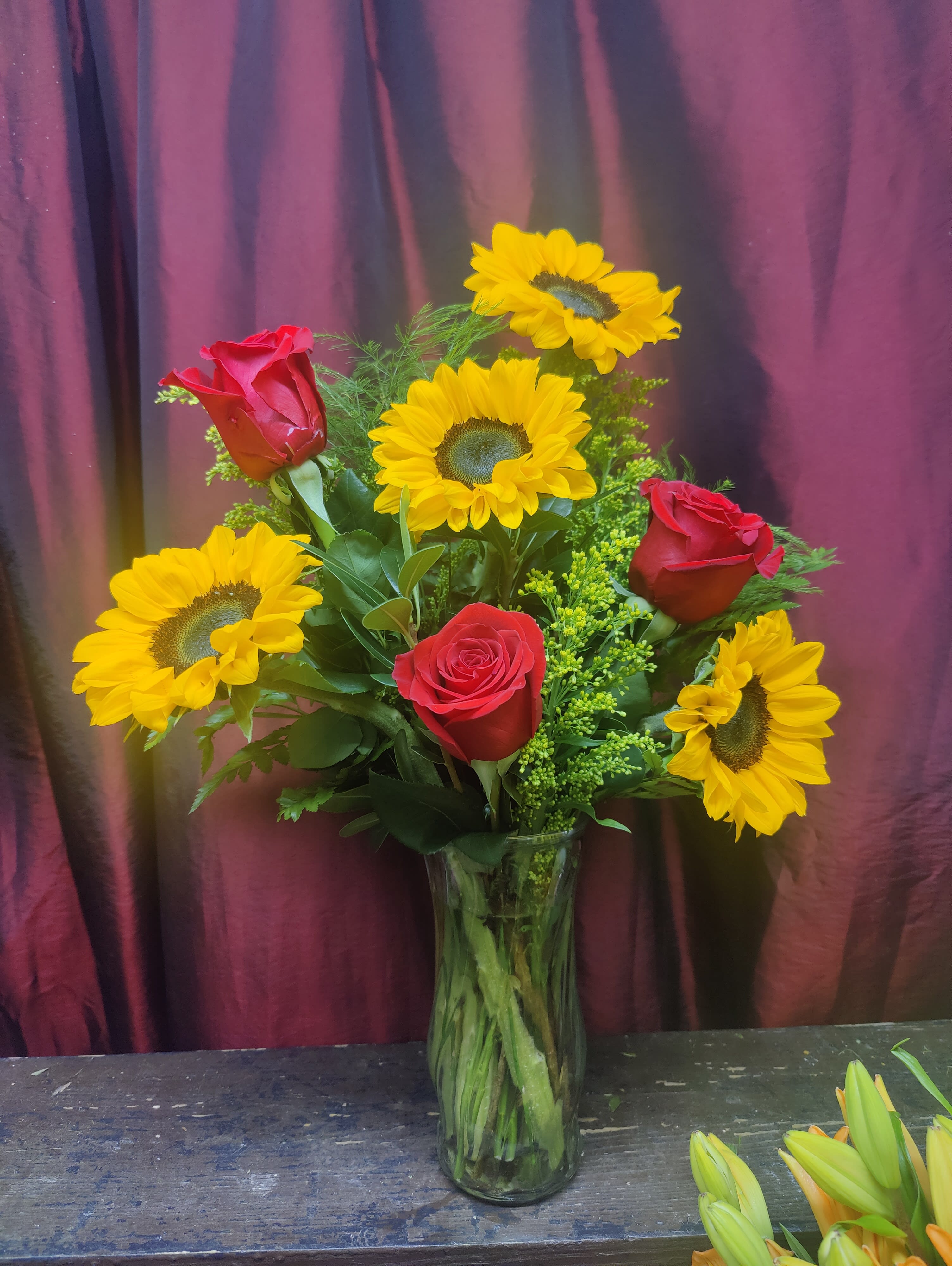 Sunflowers In Love Bouquet - Red roses represent love and romance. Combining the enamored red rose abnd the bright and ever vibrantly eye-catching sunflowers, fiery magic will happen. 