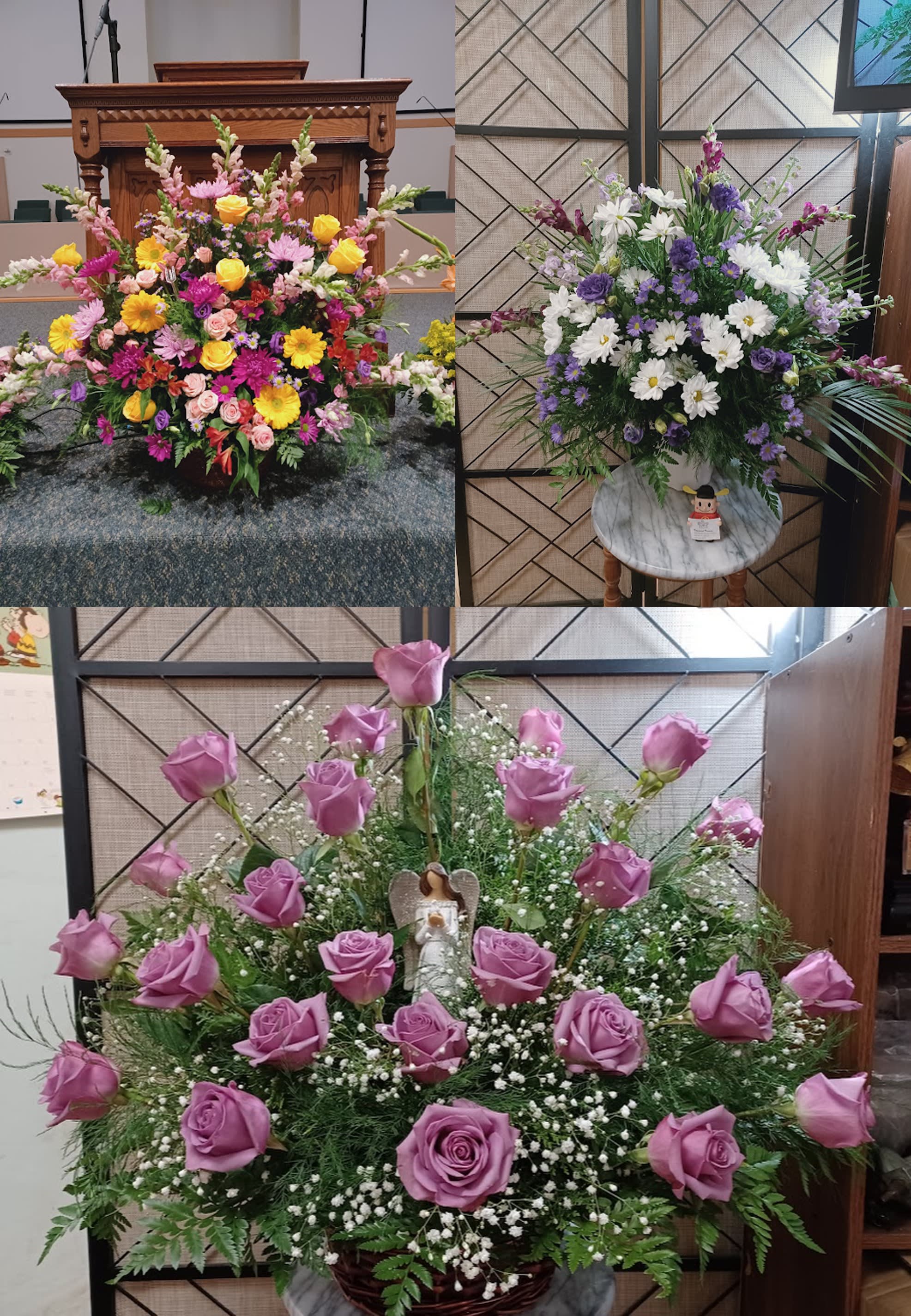 Three large floral arrangements with roses, daisies, and mixed blooms in a church setting.