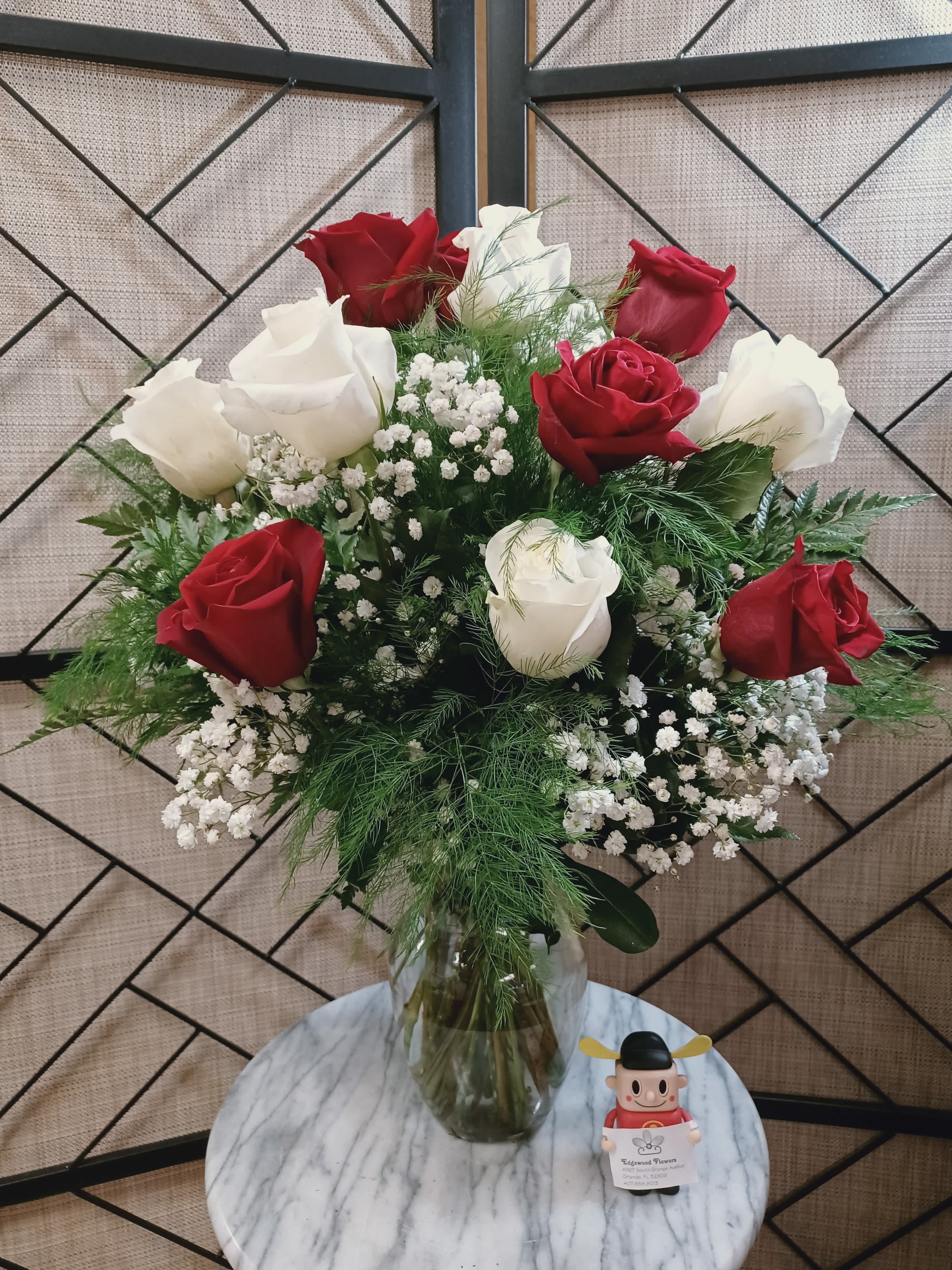 Truly and Deeply in Love Rose Bouquet  - Romantic and elegant, our Truly and Deeply in Love Rose Bouquet features a stunning mix of red and white roses, artfully arranged in a vase with lush foliage and delicate baby's breath. A timeless expression of love and devotion.  The STANDARD version includes 12 roses. The DELUXE version includes 18 roses. The PREMIUM version includes 24 roses.