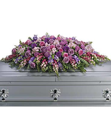 Large pink and purple floral spray on a silver casket