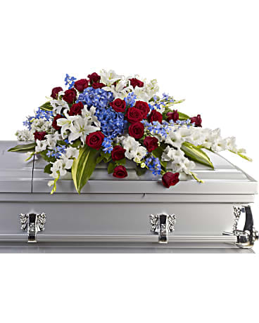 Red roses and white lilies arranged on a silver casket