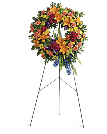 Standing floral wreath on an easel with mixed bright flowers