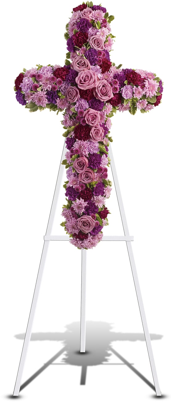 Purple and pink floral cross on a white stand