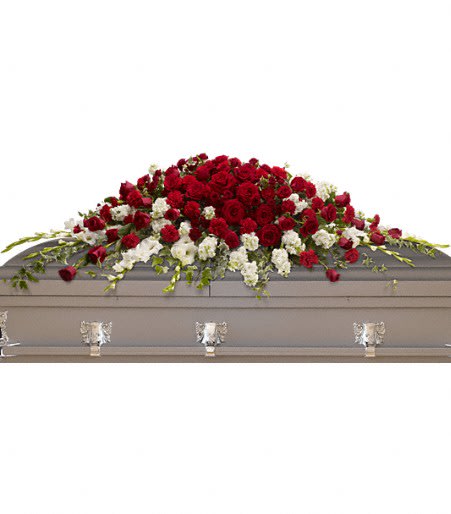 Red and white floral casket spray on a gray casket