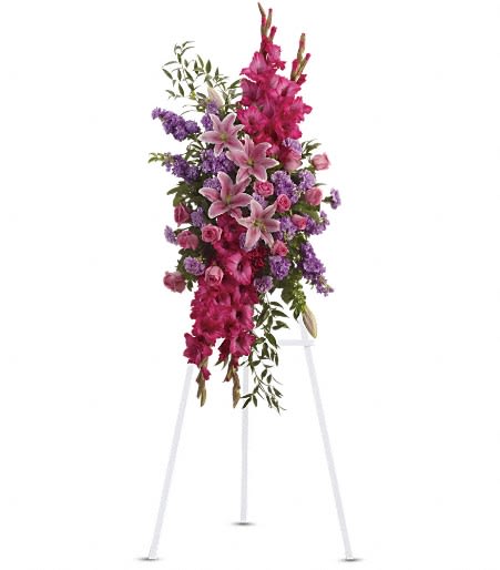 Tall pink and purple floral spray on a white stand