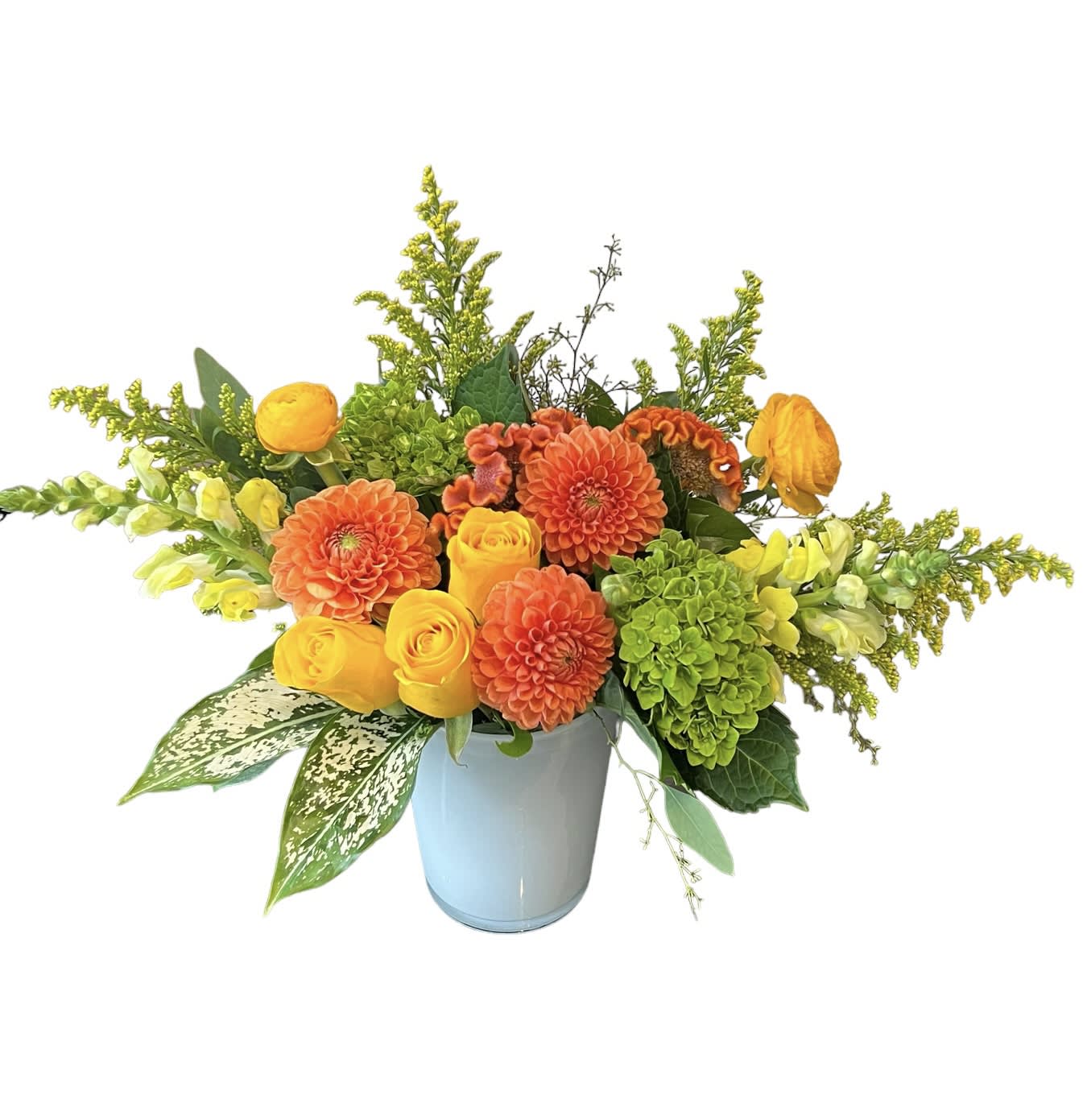 Sunny Summer  - Orange dahlias, yellow ranunculus, yellow roses, orange celosia, green hydrangeas, yellow snapdragon, yellow aster, eucalyptus designed in a white glass vase. As shown.