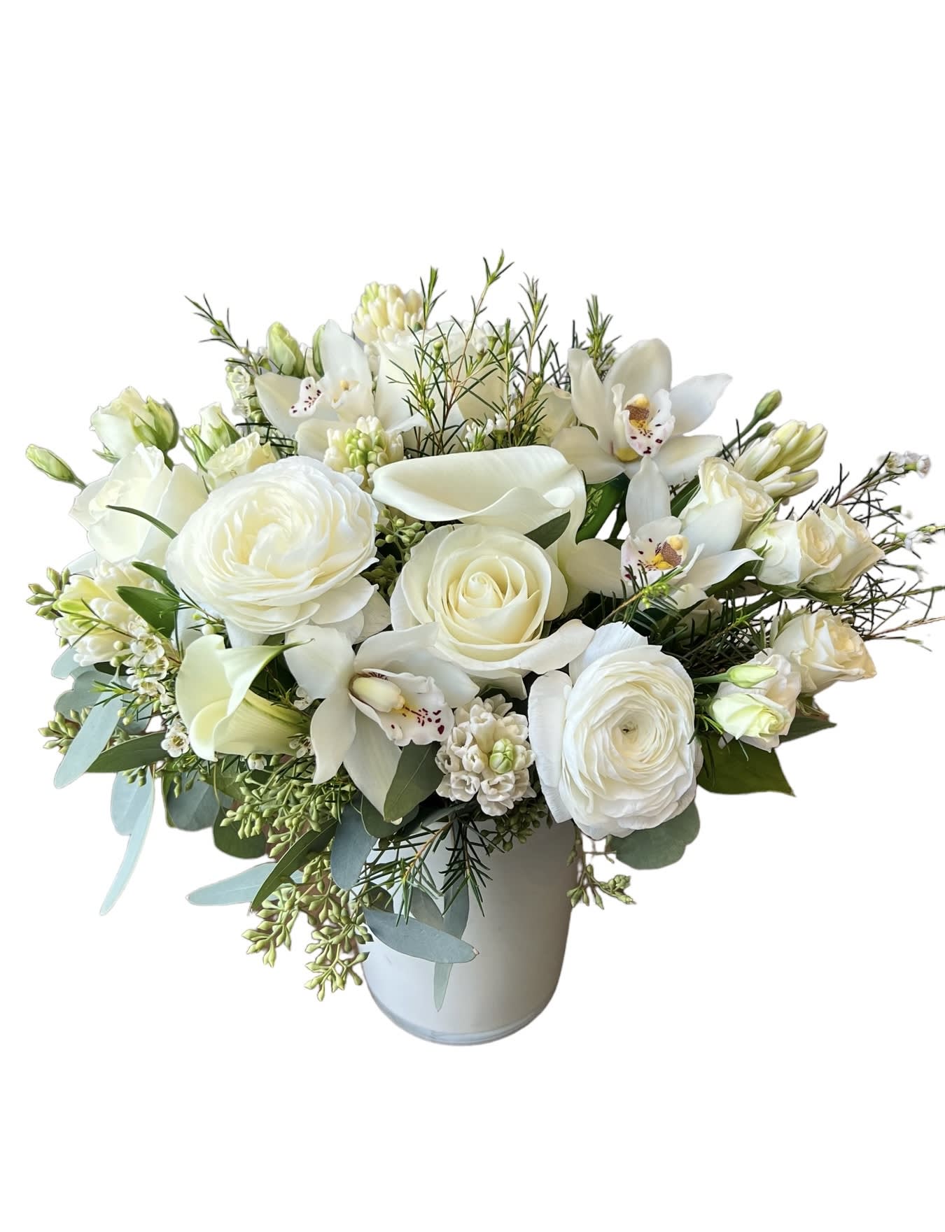 White floral arrangement in a pale vase with roses, calla lilies, and orchids