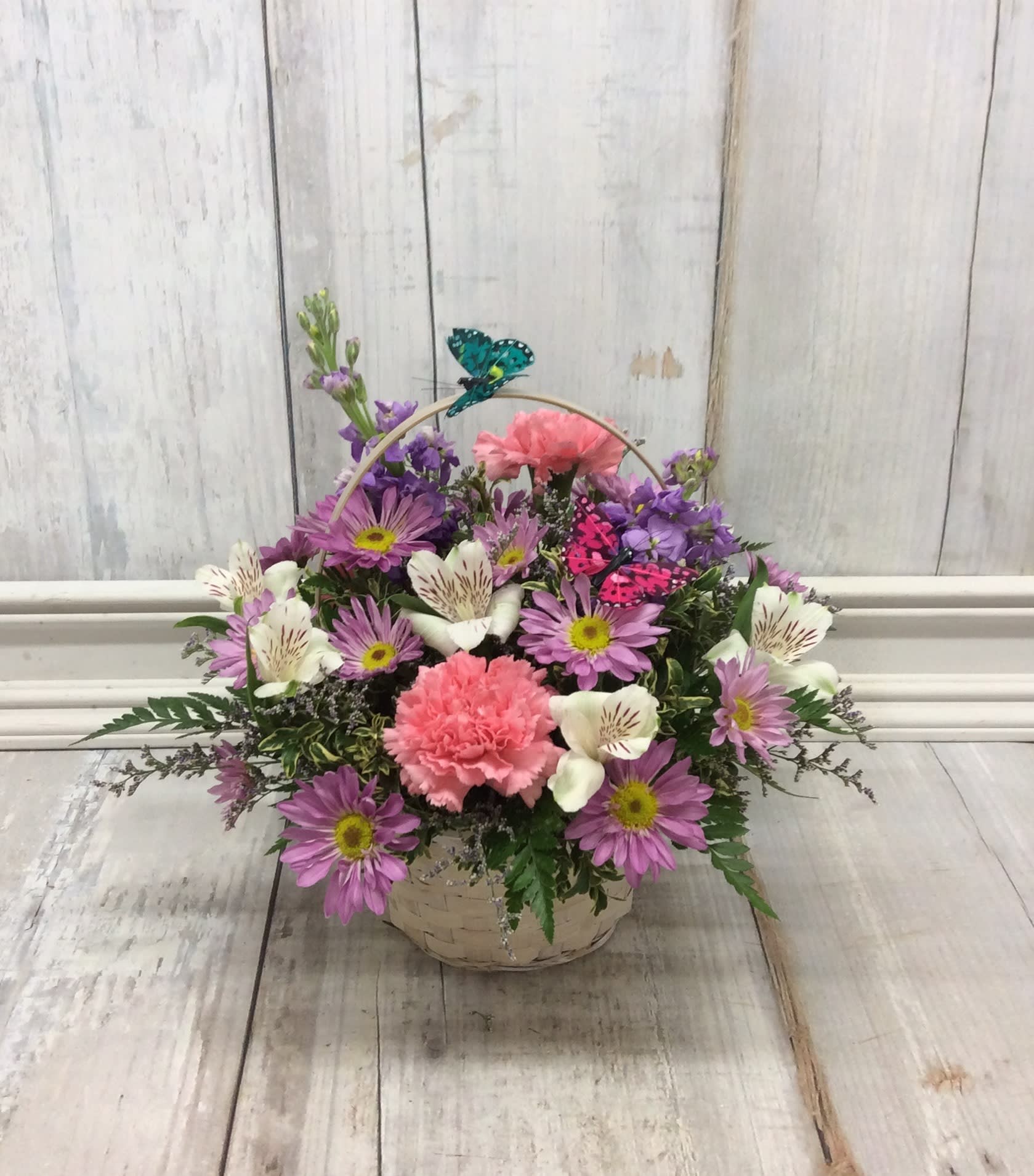 Butterfly Basket - A basket filled with soft, romantic flowers and accented with butterflies! 