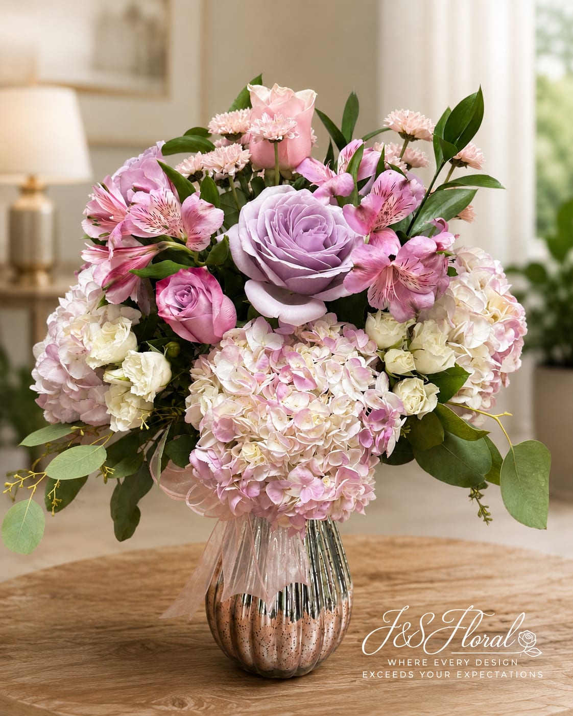Pink and lavender bouquet with roses, hydrangeas, and alstroemeria in a metallic vase