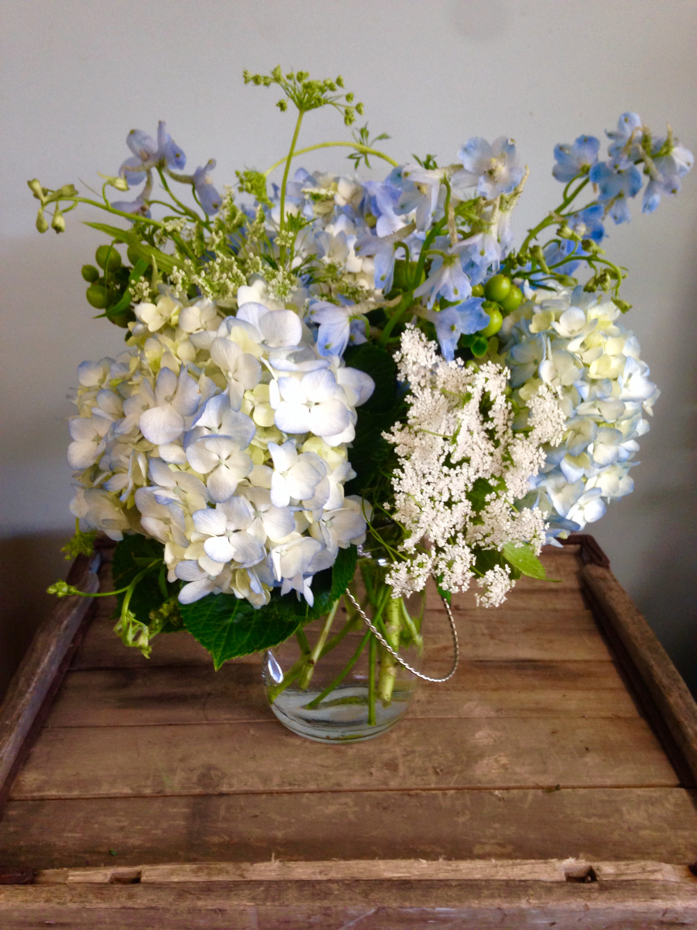 Blue and white hydrangea bouquet in a clear glass vase